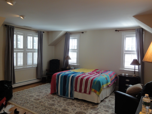 Bedroom windows with white shutters