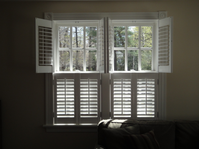 White-stained plantation shutters